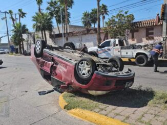 Conductora omite luz roja y provoca choque volcadura en las Industrias